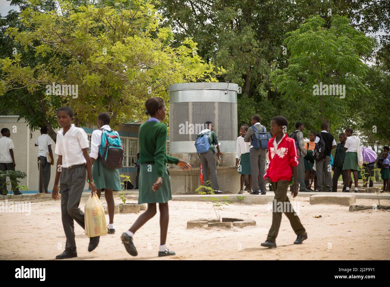 School students access clean drinking and washing water from a fountain in their school courtyard in Oshana Region, Namibia, Africa. Stock Photo