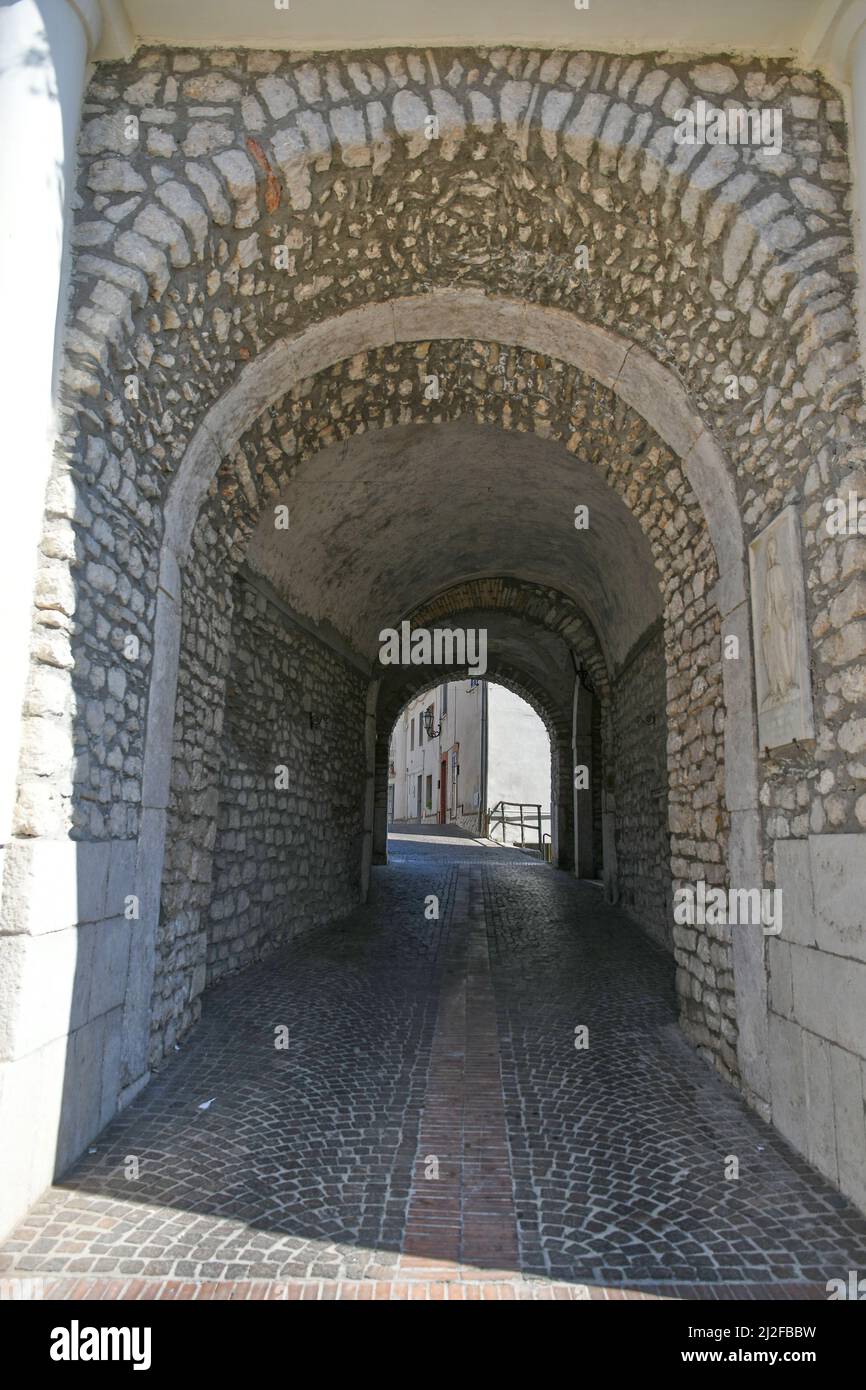 A vertical shot of a narrow alley between medieval stone buildings in ...