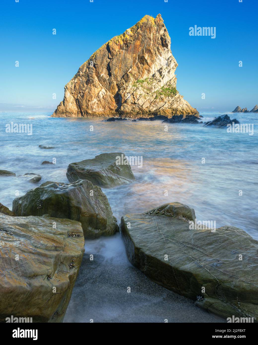 Variety of rocks polished by sea water in front of Coitelo on a beach in Loiba Espasante Galicia Stock Photo
