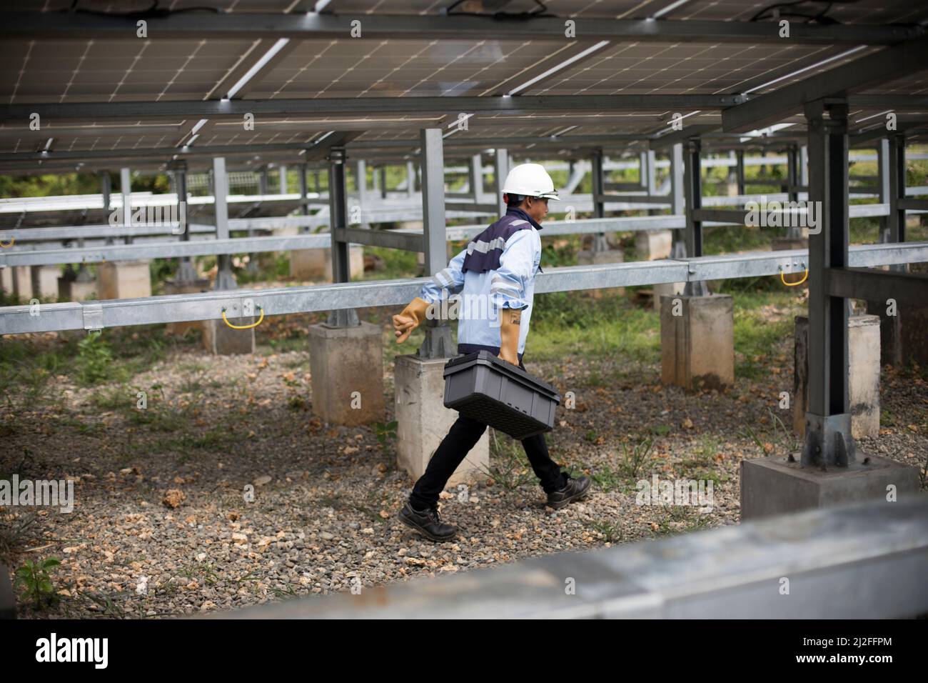 Junior electrical technician, Aldi (25), inspects and maintains solar panels on Karampuang Island, Indonesia, which were installed as part of the Gree Stock Photo