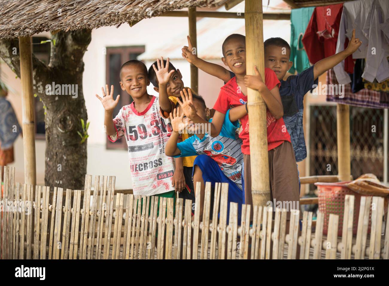 A group of children huddle together on Karampuang Island, Indonesia, which has received solar-powered electricity for the first time under the Green P Stock Photo
