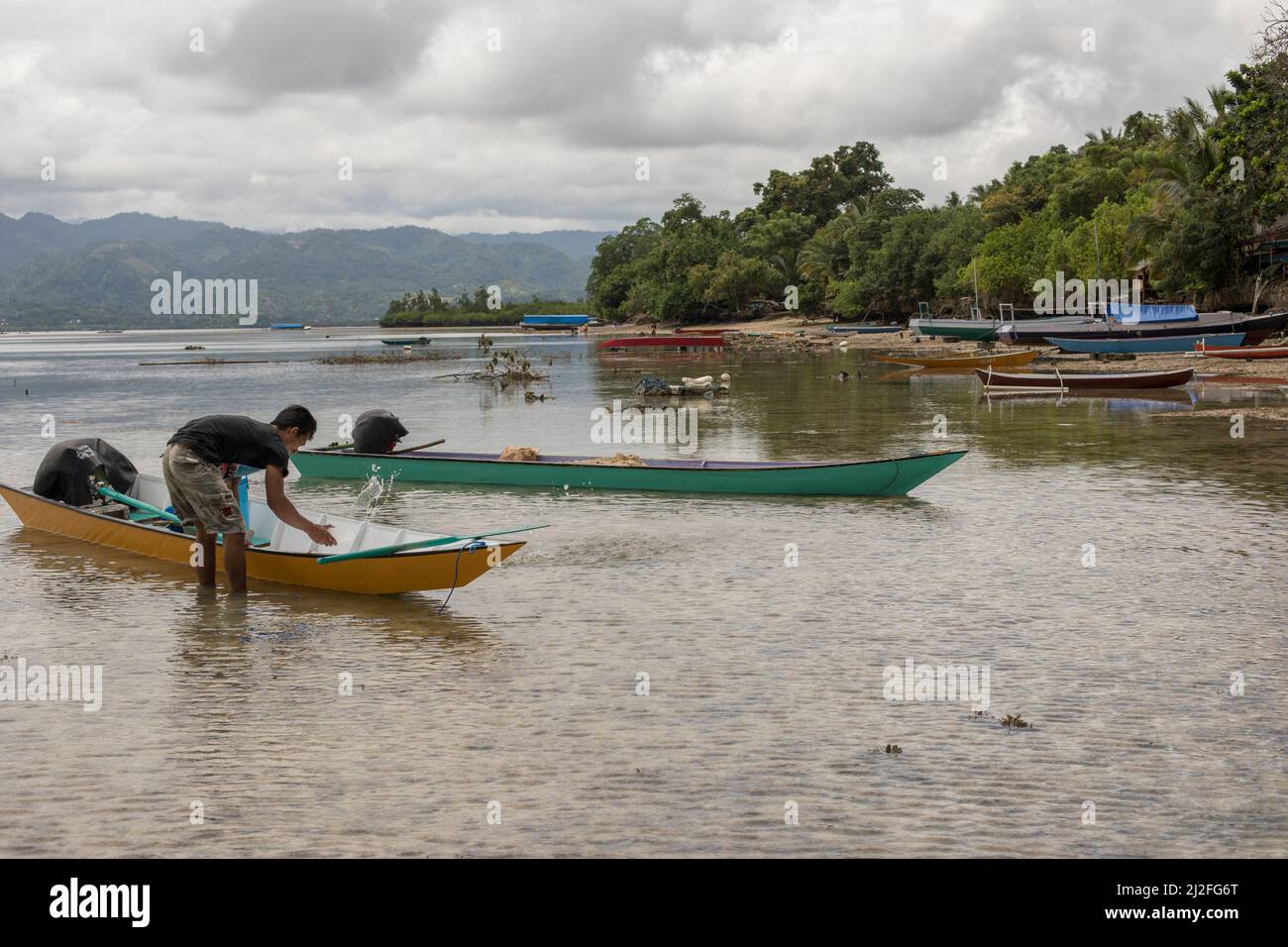 Small fishing boats anchor on the shoreline of Karampuang, Indoneisa, which is off the coast of Mamuju, Sulawesi. Stock Photo