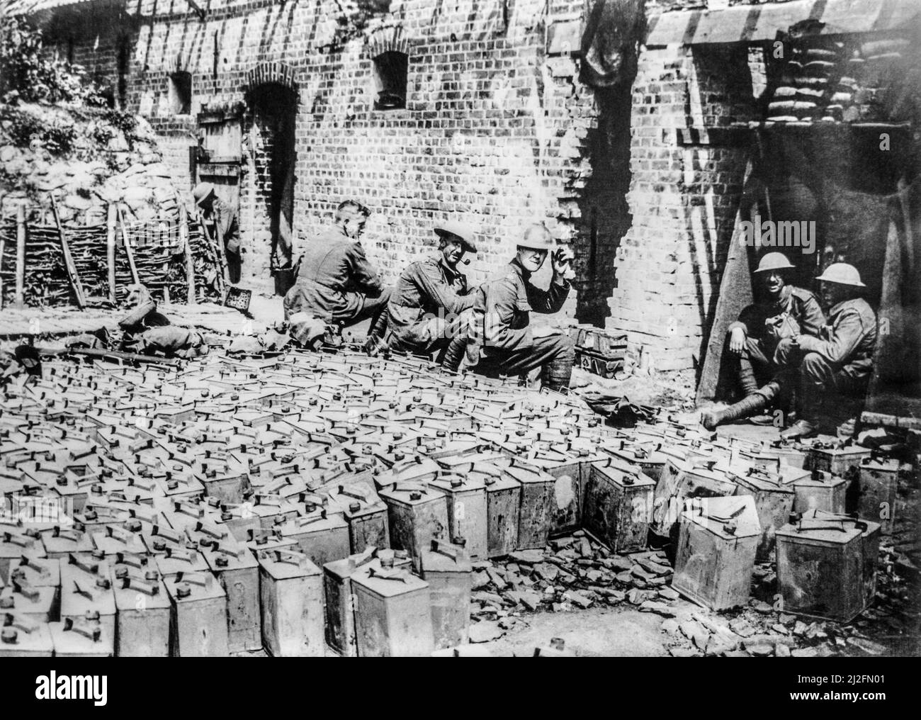 WWI British soldiers with jerrycans at water-filled petrol tin dump at Elverdinghe, West Flanders, Belgium in 1917 during First World War One Stock Photo