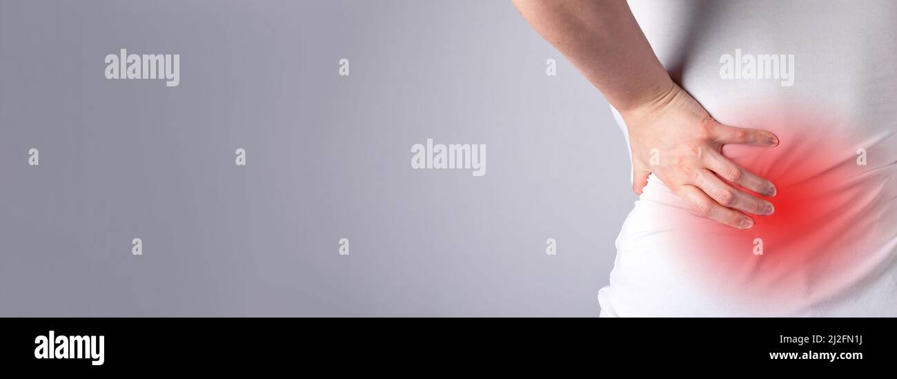 Banner with backache, lower back pain with red spot closeup. Muscle spasm, sprains, strains