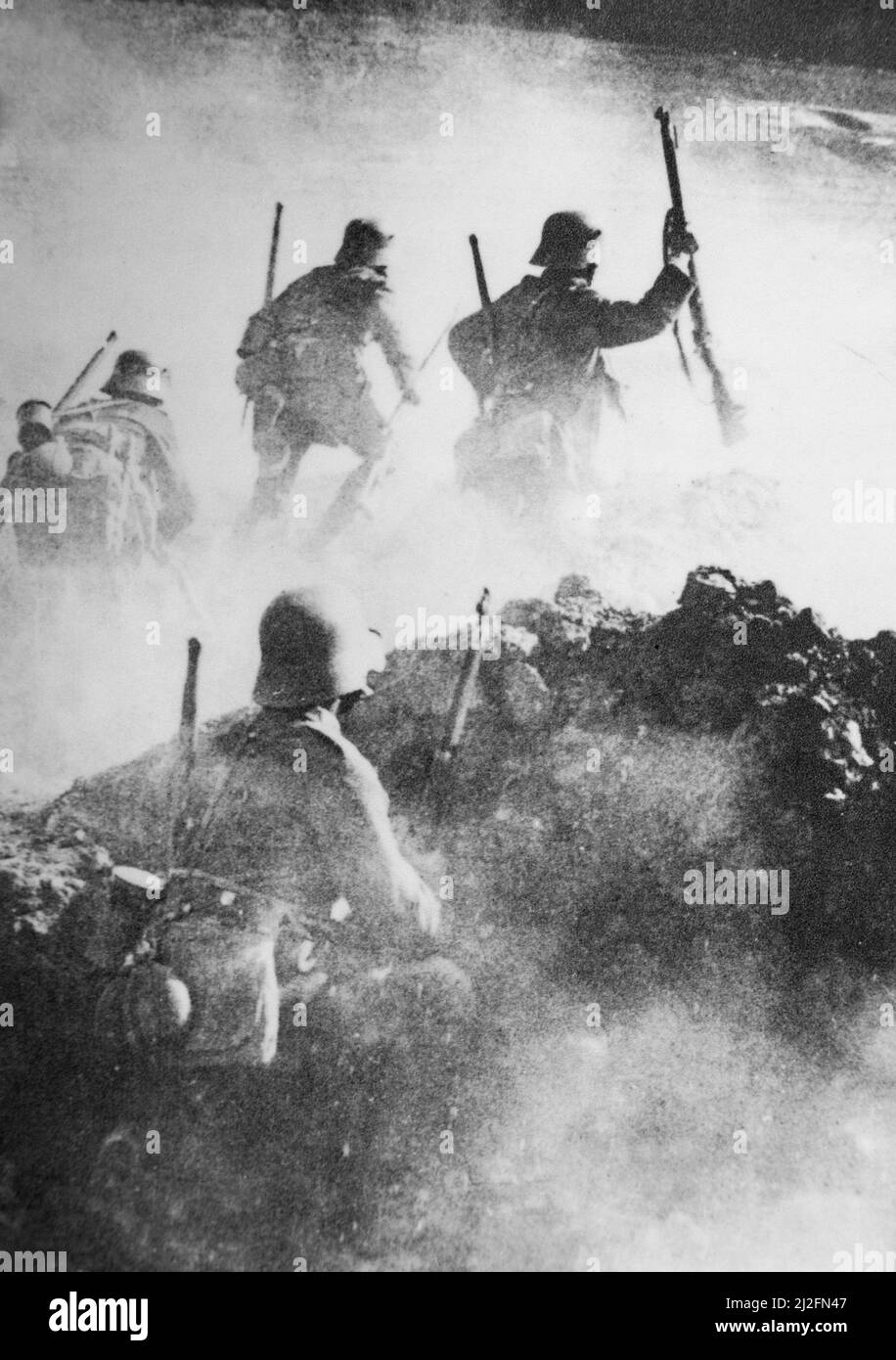 German WWI stormtroopers advance through clouds of smoke towards enemy positions on the Western Front during the Spring Offensive of 1918 Stock Photo