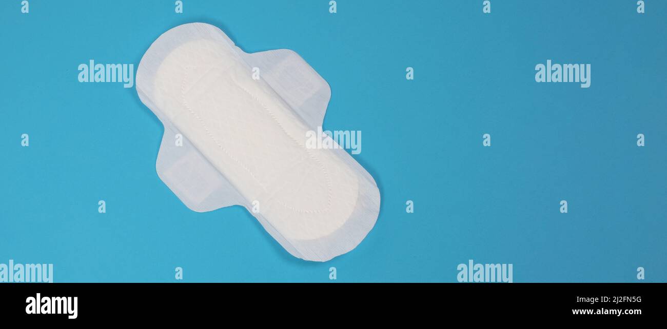 Woman sanitary napkins on blue background. Top view. Absorbent pads