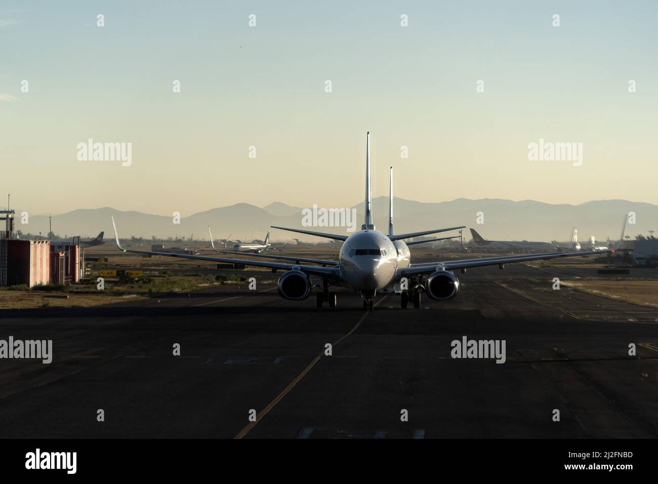 airplane queue before take off at sunset in mexico city airport Stock Photo