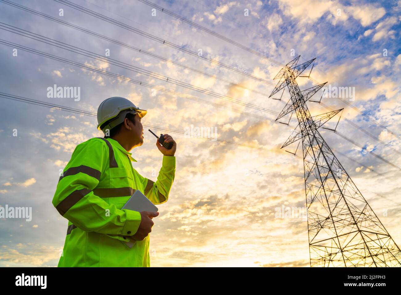 Asian engineer use radio checks at a power station for planning work by