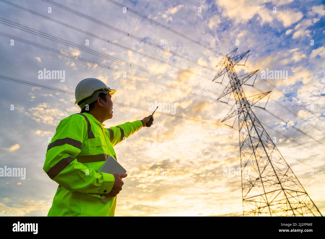 Asian engineer checks at a power station for planning work by
