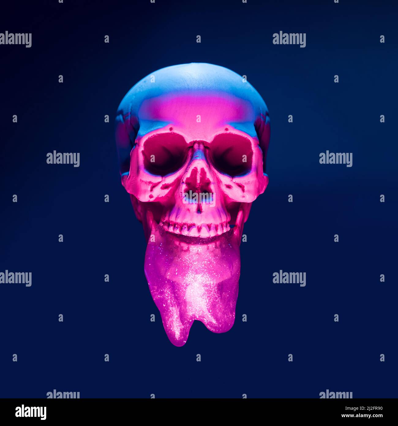 Skull with neon lights and slime floating over the black background. Cyber death concept. Stock Photo