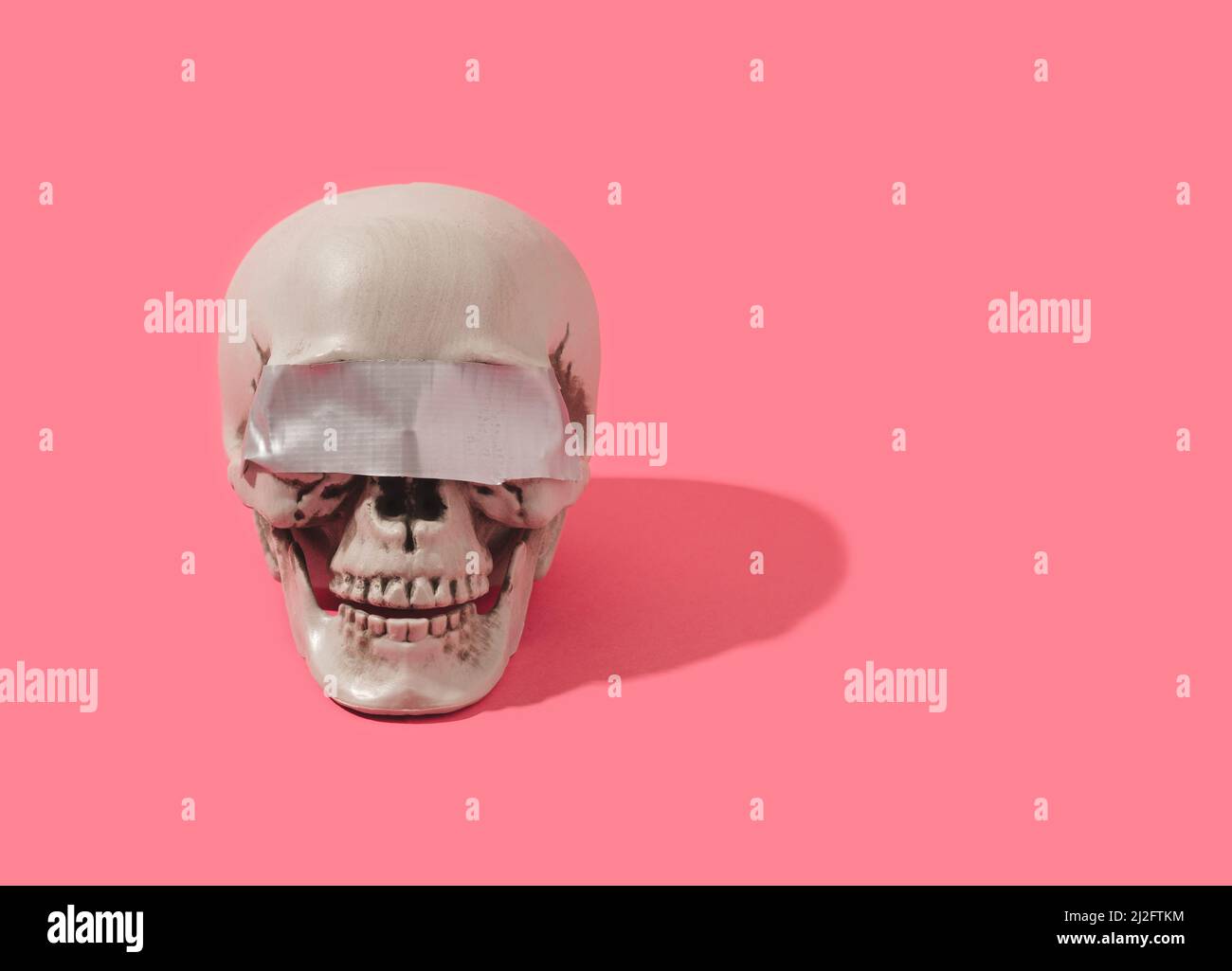 Human skull with duct tape over its eyes. Blind truth conceptual background. Stock Photo