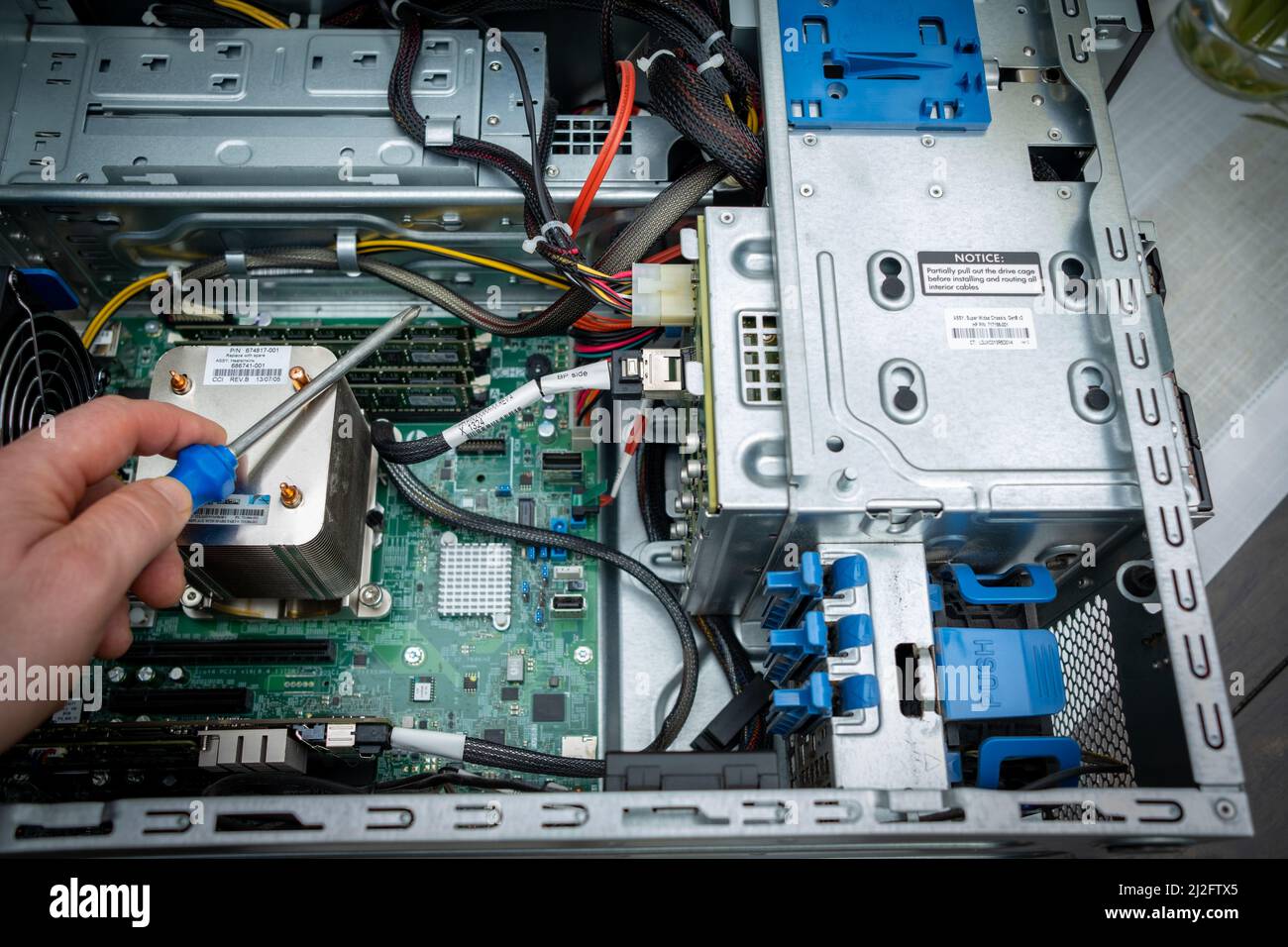 a screwdriver is held in an unscrewed PC Stock Photo