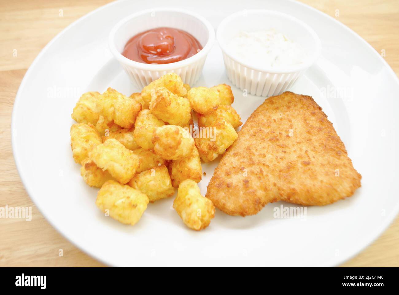 Breaded Haddock Fish and Tater Tots as a Quick Dinner Stock Photo Alamy