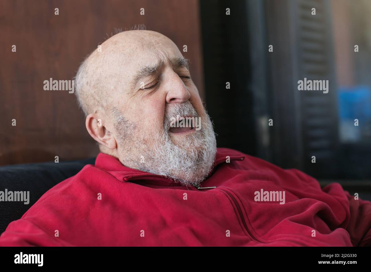 elderly man singing at his home Stock Photo