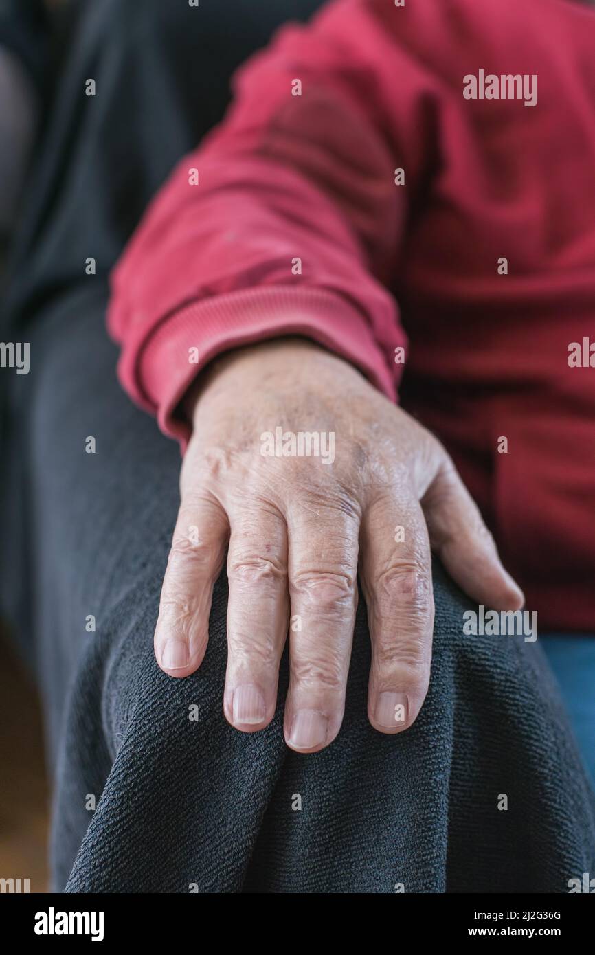 elderly person's hand resting on armchair Stock Photo - Alamy