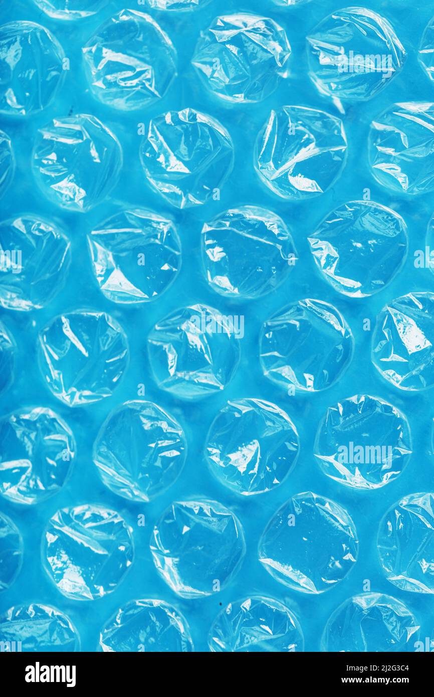 Packing bubble wrap for parcels on a blue background in full screen Stock Photo