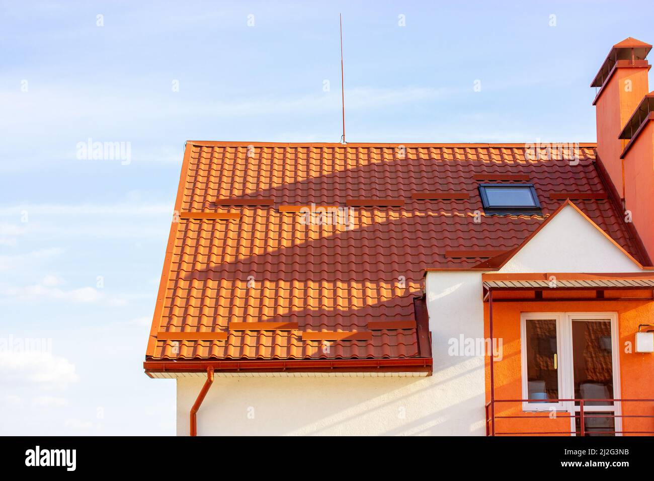 Picture of Facade of new white apartment building with red terra cotta tile roof ...