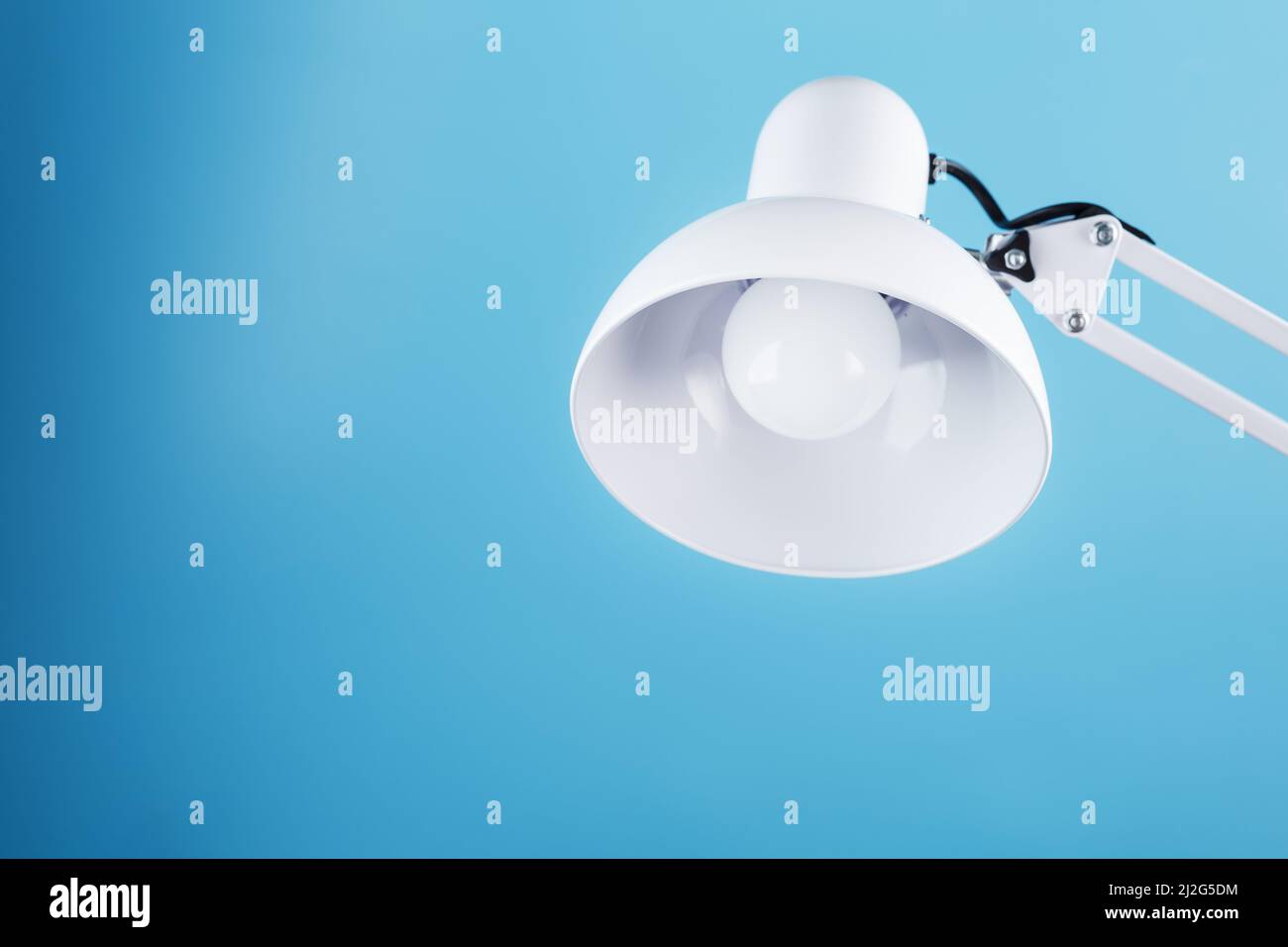 Office table lamp on blue background with space for text and idea concept Stock Photo