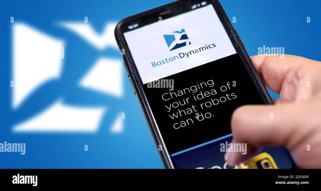 Waltham, MA, USA March 2022: Boston Dynamics company’s website on a phone screen. Blue background with Boston Dynamics icon blurred in the background. Stock Photo