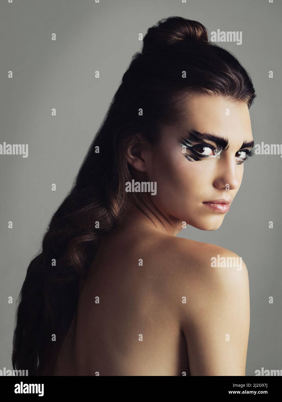 Makeup is my spirit animal. Studio shot of an attractive young woman wearing bold eye makeup. Stock Photo