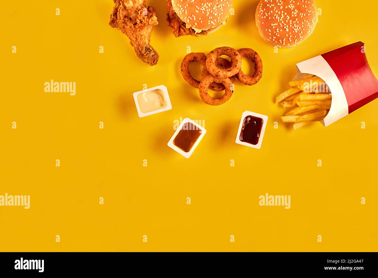 Fast food dish top view. Meat burger, potato chips and chicken. Take