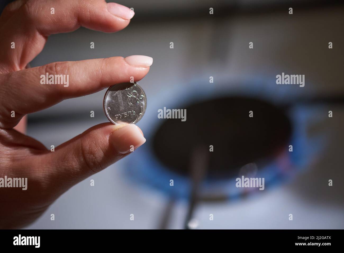 Russian money ruble on the background of a gas stove, the concept of buying gas for rubles Stock Photo
