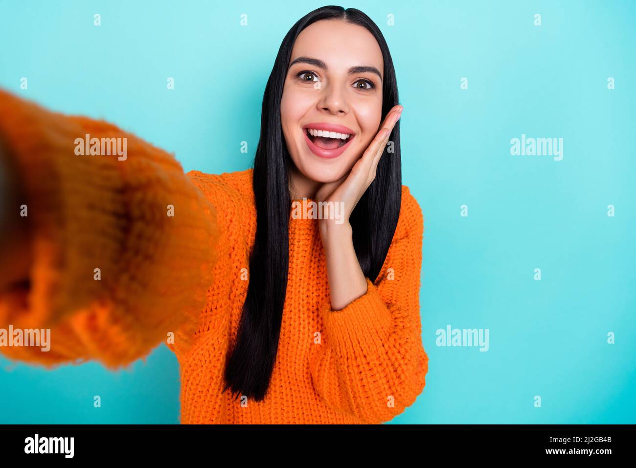 Photo of sweet impressed lady dressed knitted pullover recording self video arm cheek isolated teal color background Stock Photo