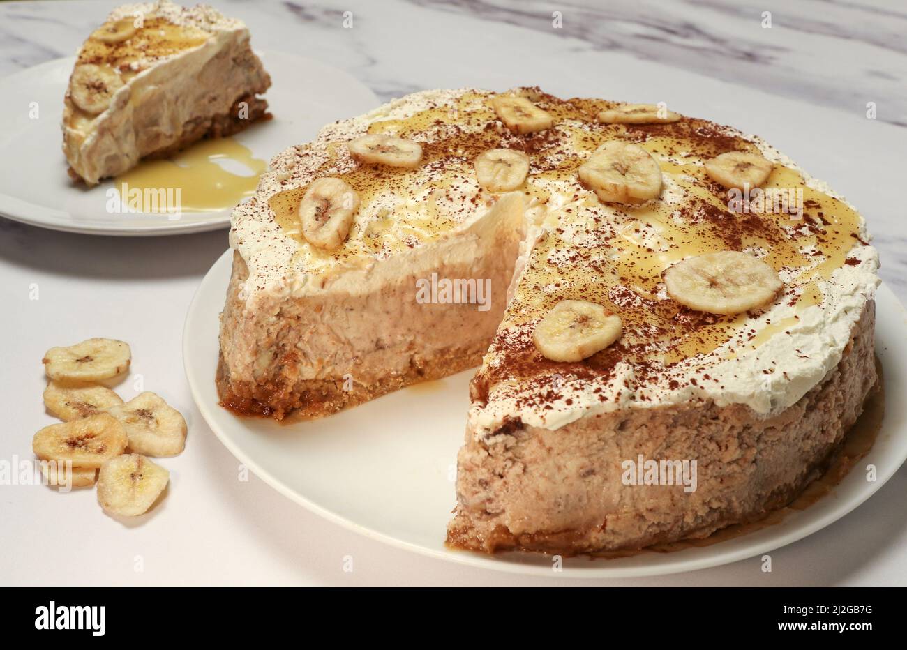 carameldrizzled banoffee bake with slice and banana chips Stock Photo