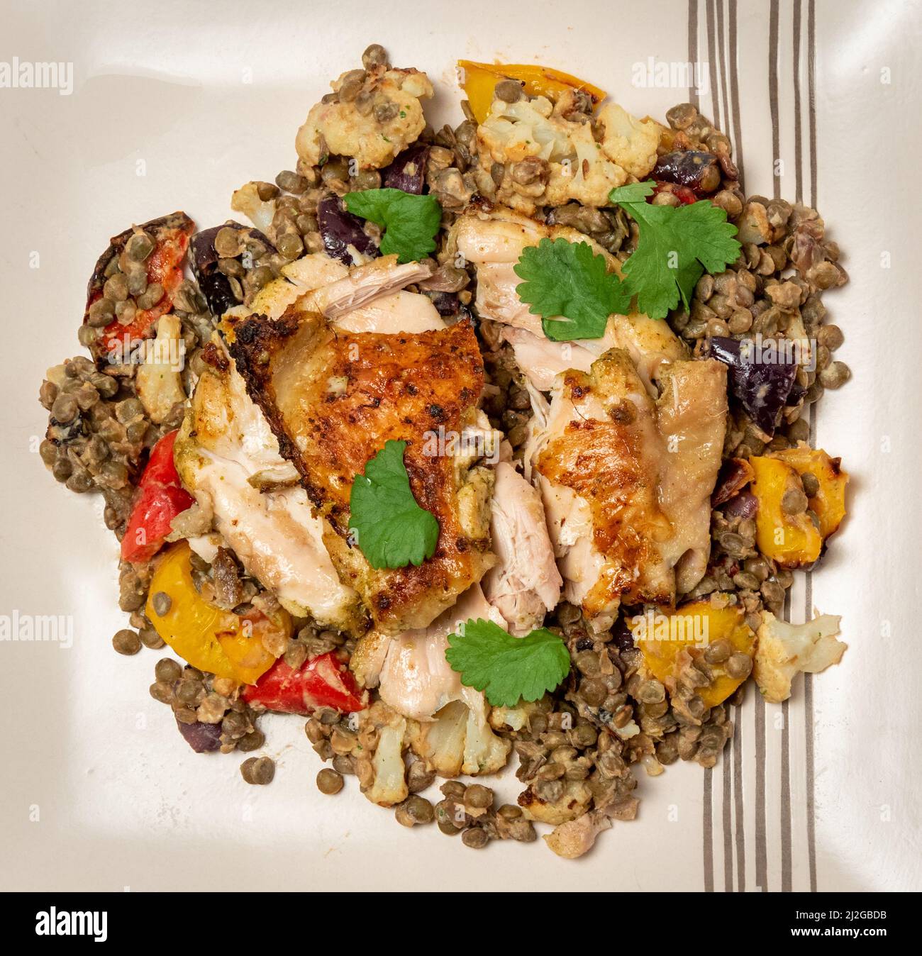 Coriander roast chicken thighs with puy lentil salad Stock Photo Alamy