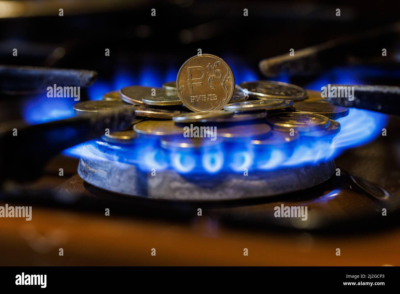 gas stove burner with russian ruble standing vertically on top, burning gas Stock Photo Alamy