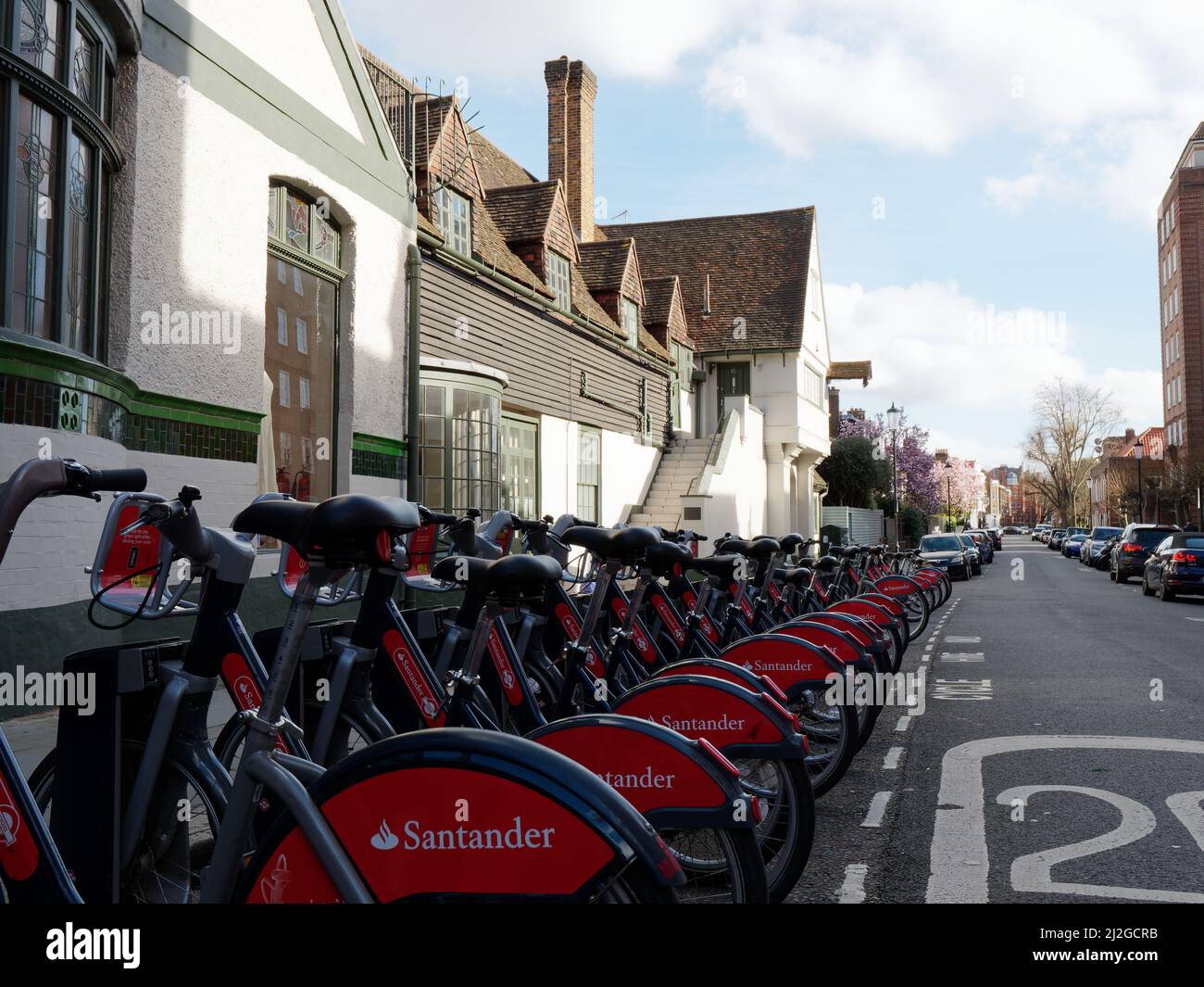 London, Greater London, England,  March 12 2022: Santander hire bikes aka Boris Bikes near Kings Road in front of a building with step access. Stock Photo