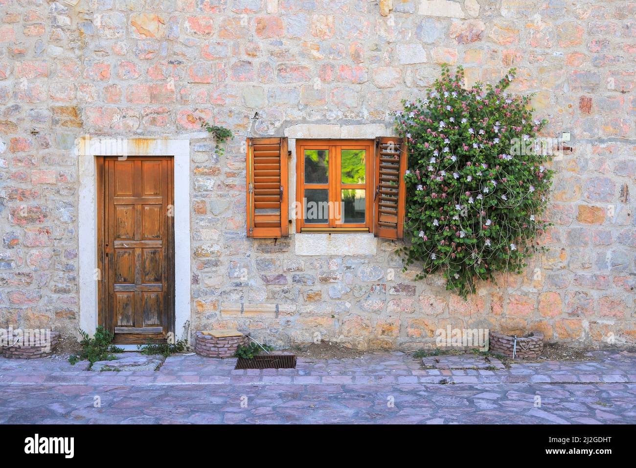 Exterior of antique stone house with window and front door Stock Photo ...