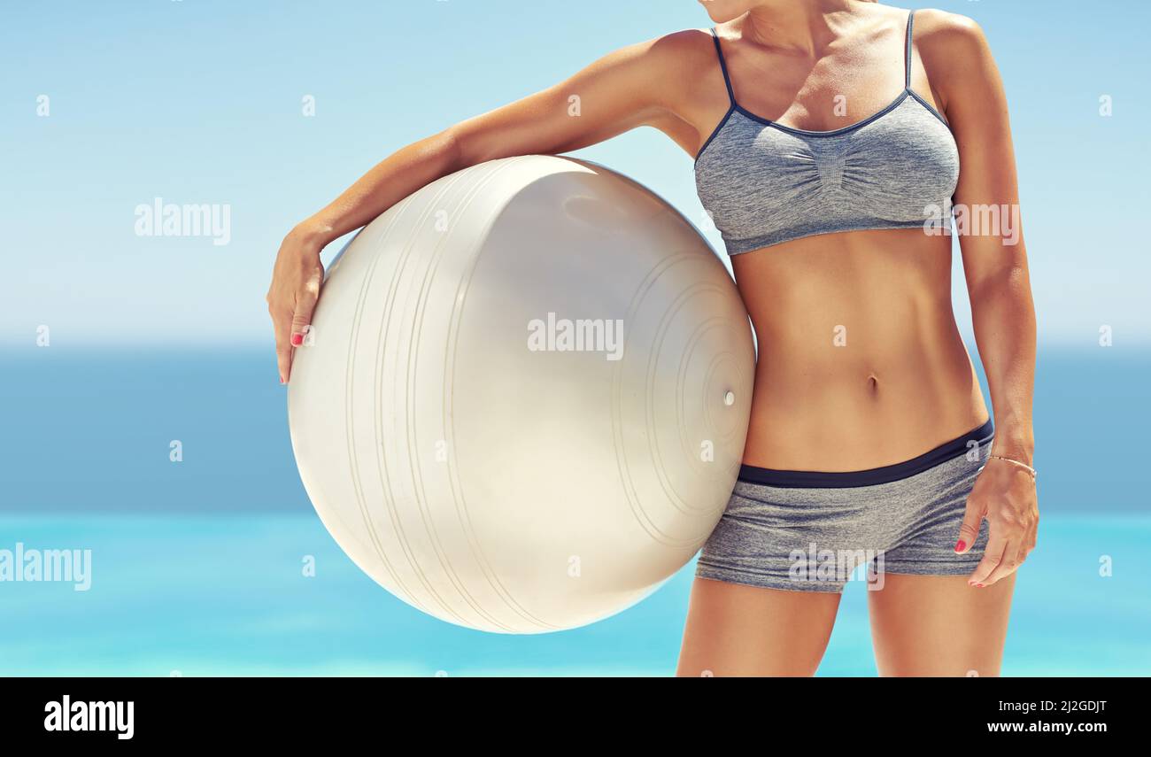Her core is super strong. Cropped shot of fit young woman holding an exercise ball. Stock Photo