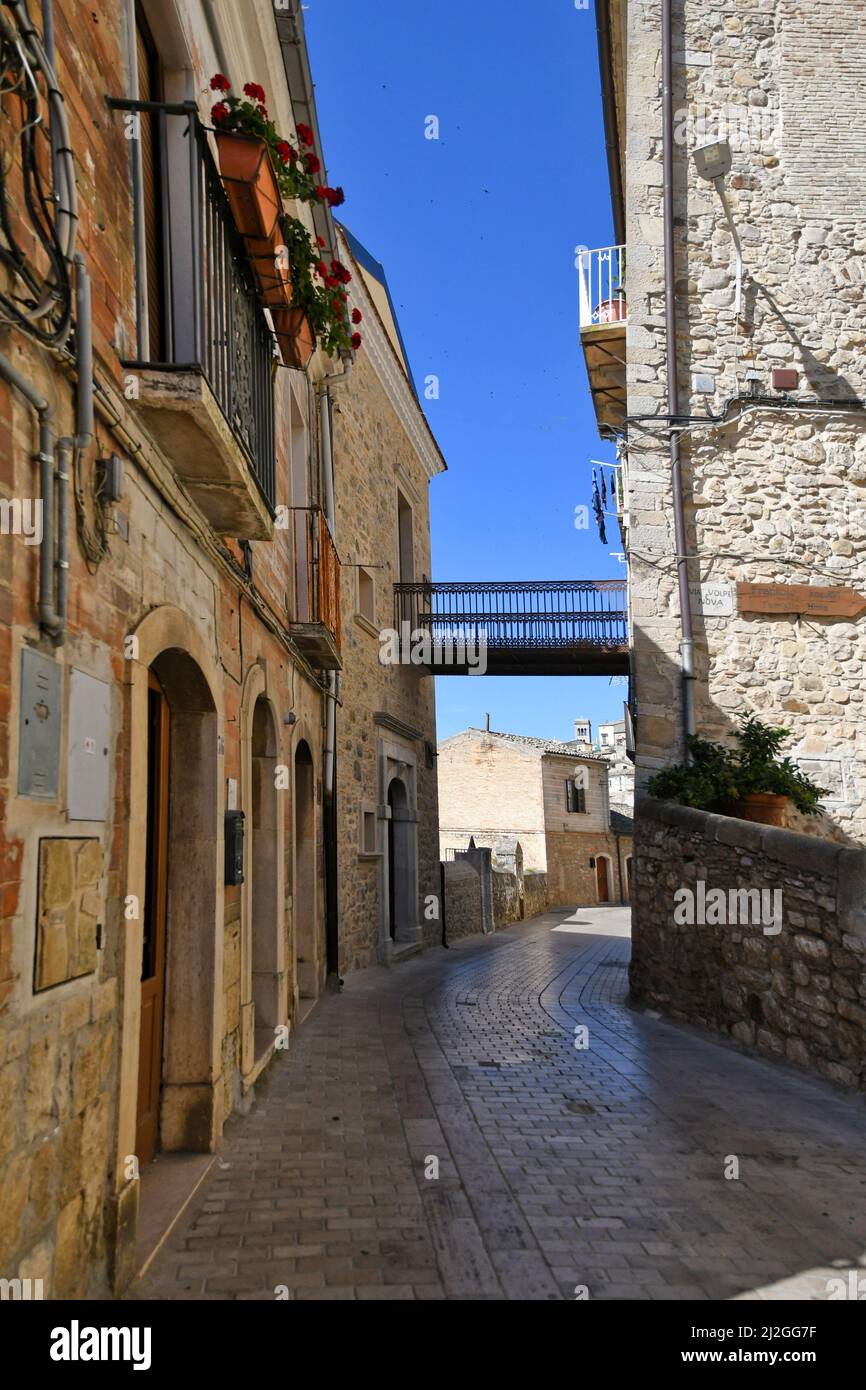 A narrow street between the old houses of Sant'Agata di Puglia, a