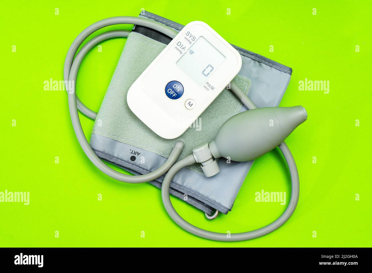 Automatic blood pressure monitor or blood pressure meter on green background. Medical equipment