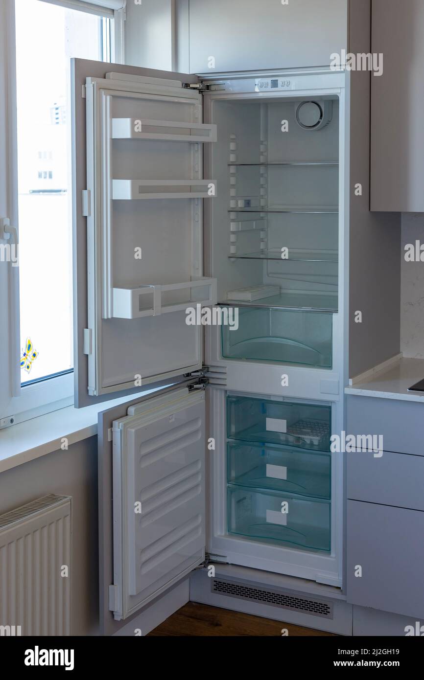 Home refrigerator with empty shelves. Lack of products. Stock Photo