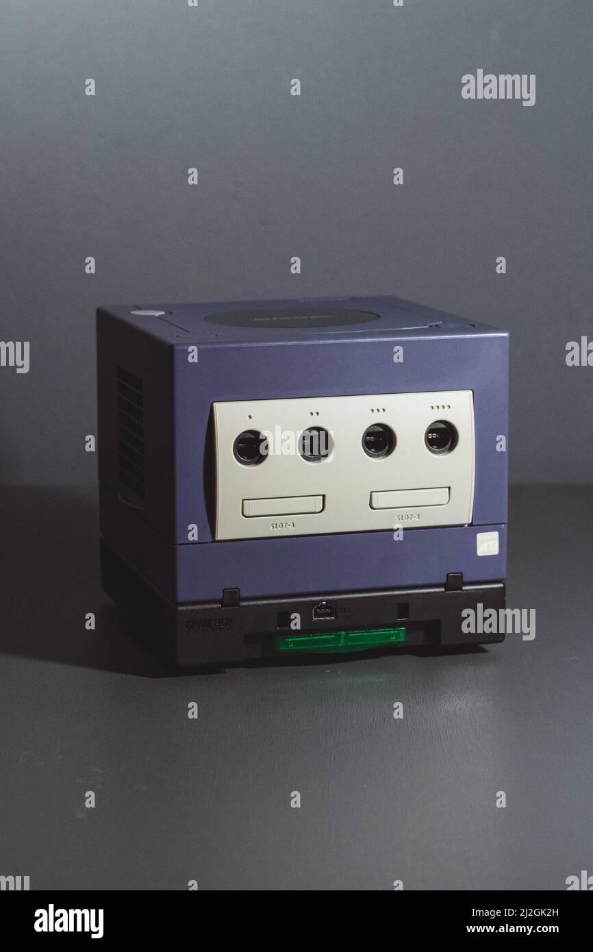 A vertical shot of the Nintendo GameCube system with a GB Player base on a gray background Stock Photo