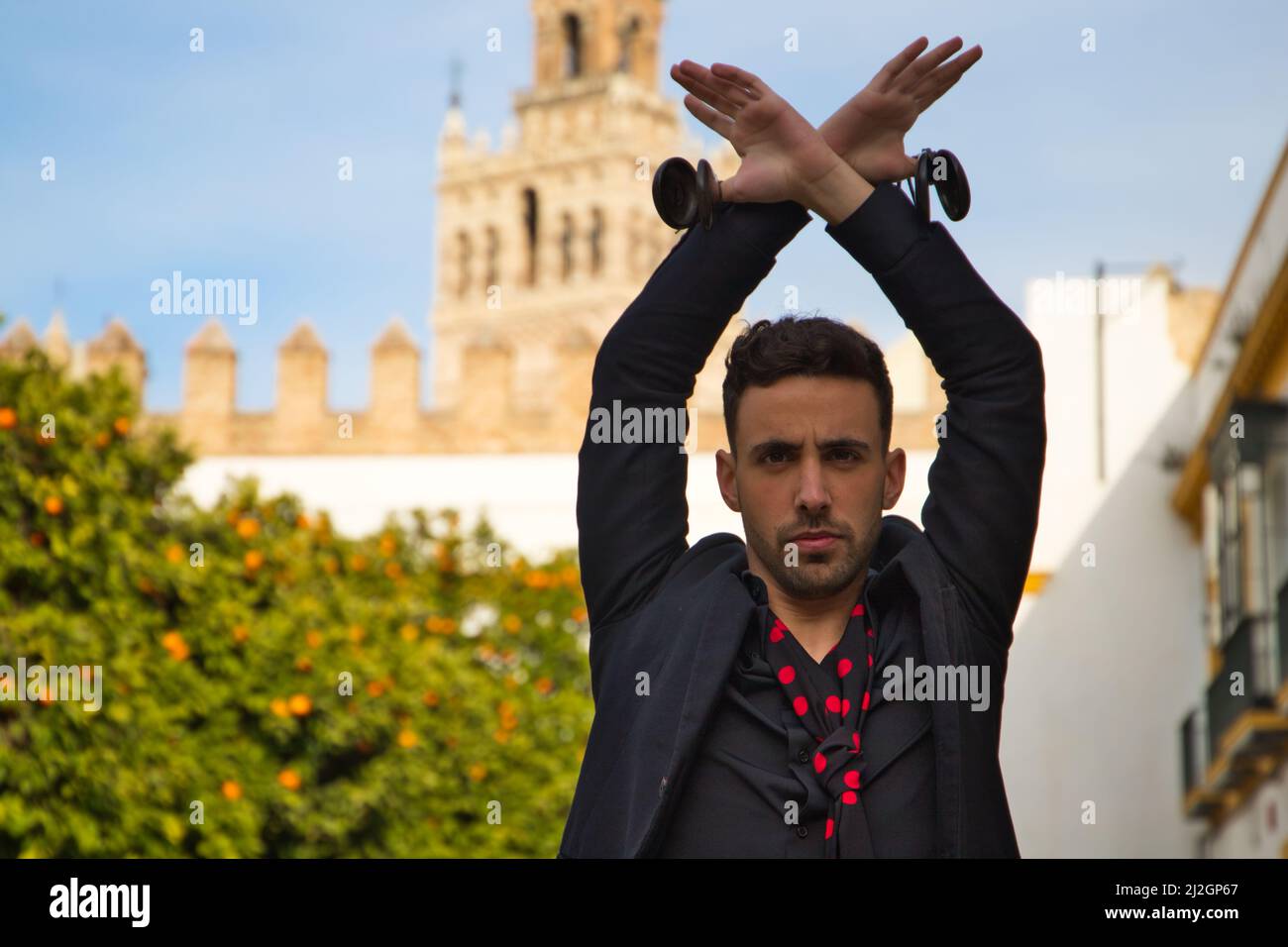 A gypsy man dancing flamenco, dressed in black with posing