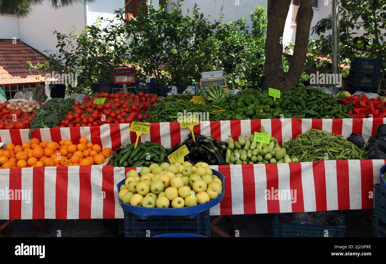 A farmer's stall in the local market. various fruits and vegetables. Springtime. Mediterranean local culture and lifestyle. Stock Photo