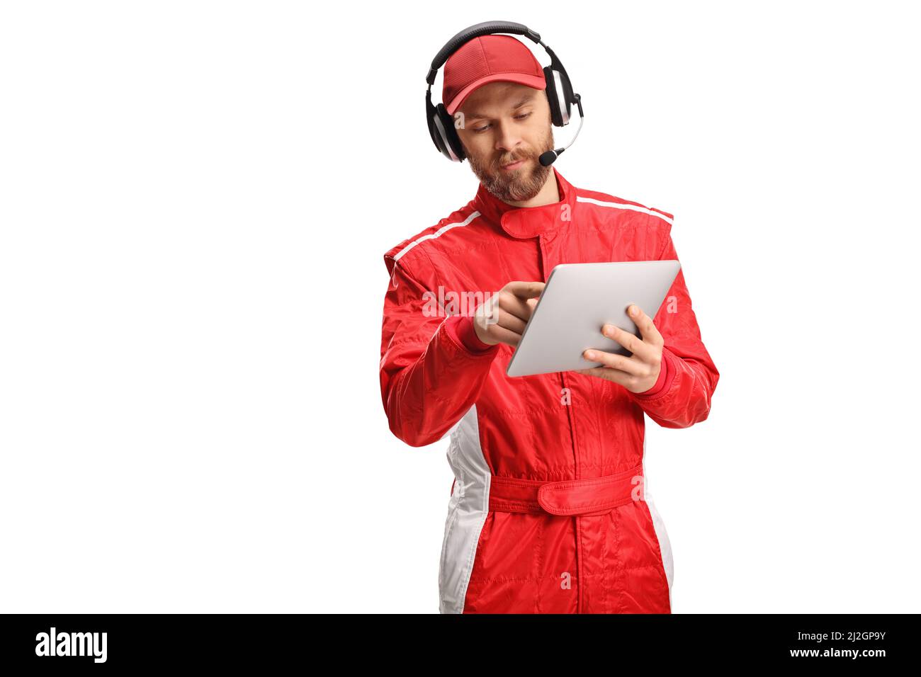 Member of a racing team with headphones holding a digital tablet isolated on white background Stock Photo