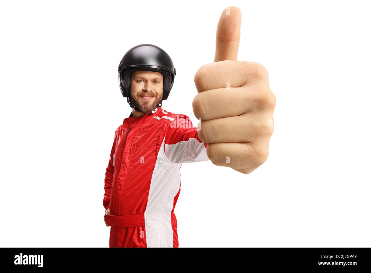 Driver in a red suit and helmet gesturing thumbs up isolated on white background Stock Photo