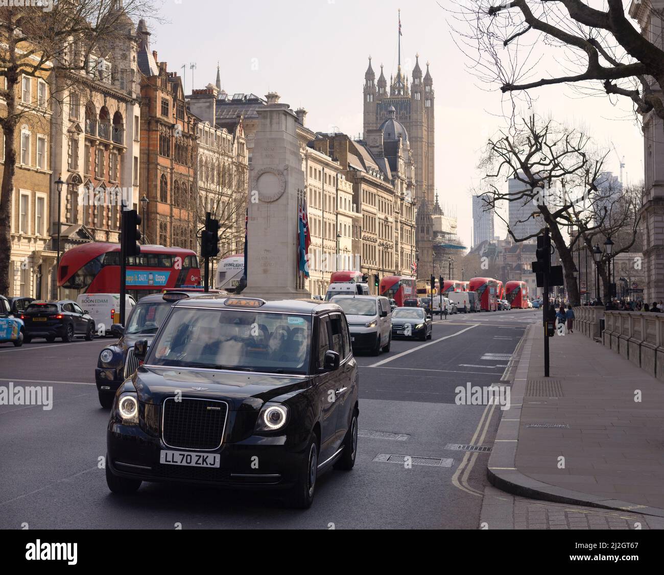 London taxi; London taxis on Whitehall, London SW1, Houses of Parliament in the background, London city centre  street scene, London UK Stock Photo