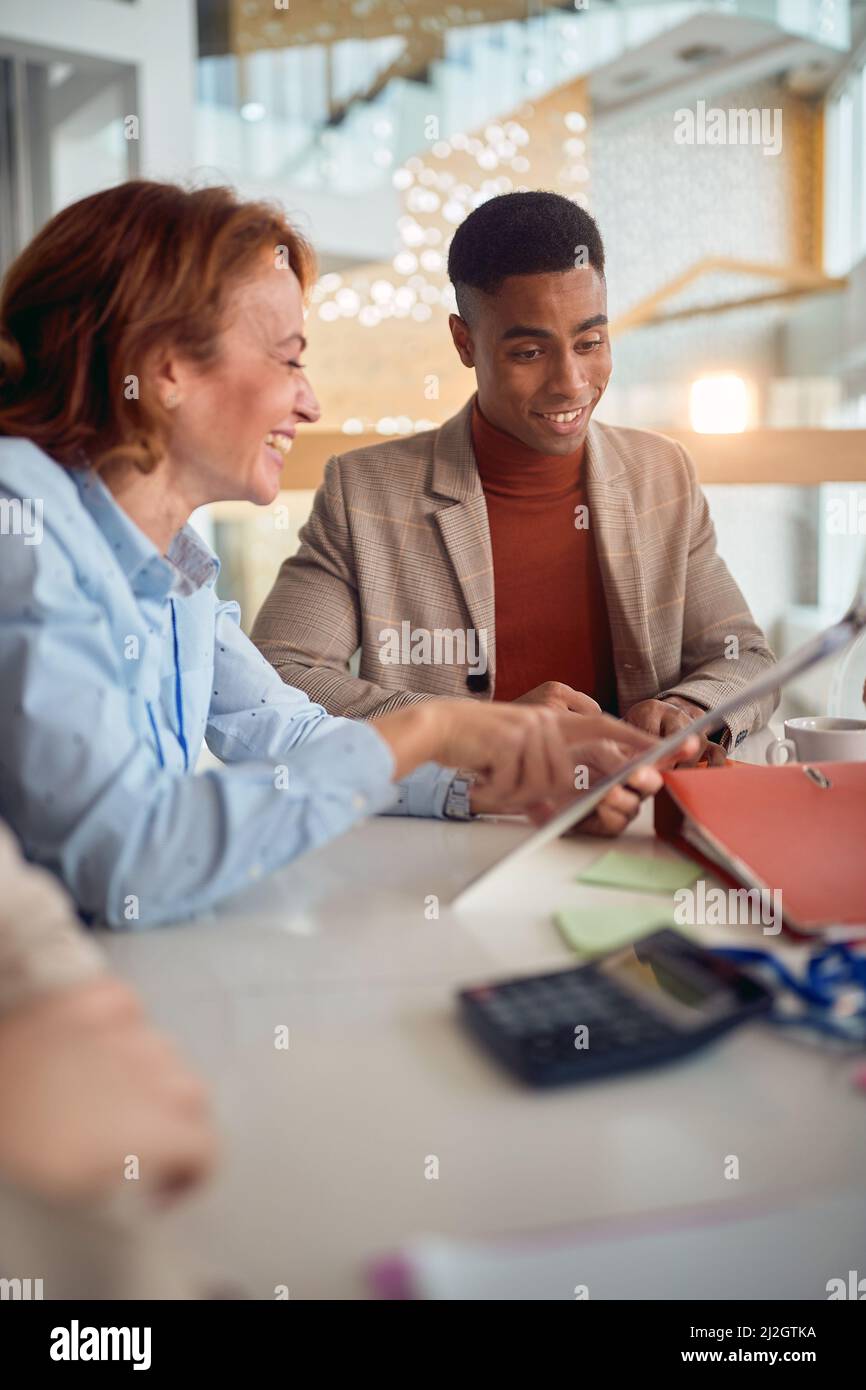 Two business colleagues in a relaxed atmosphere at the office enjoying working together. Business, people, office, company Stock Photo