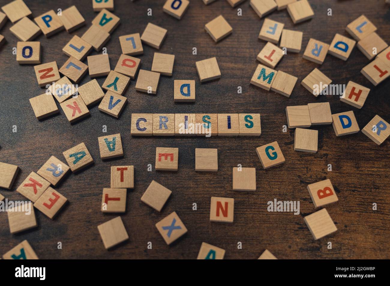 A word CRISIS composed of aligned wooden blocks with letters vocabulary game economical problems concept . High quality photo Stock Photo