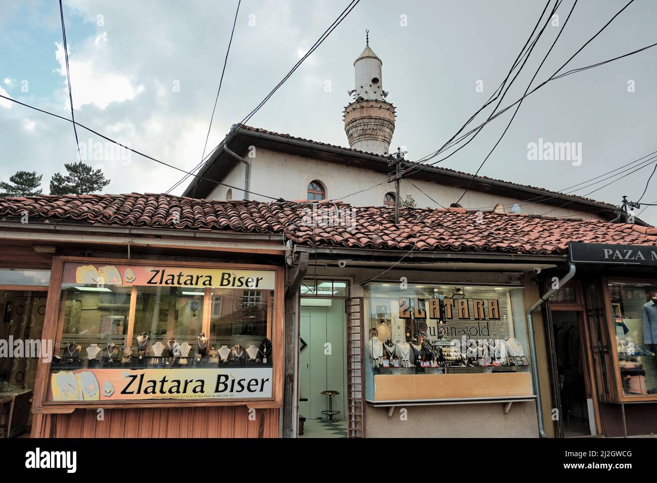NOVI PAZAR, SERBIA - JULY 25, 2017: showcases of shops specialise in gold jewellery under the minaret of Arap Mosque in dowtown Stock Photo