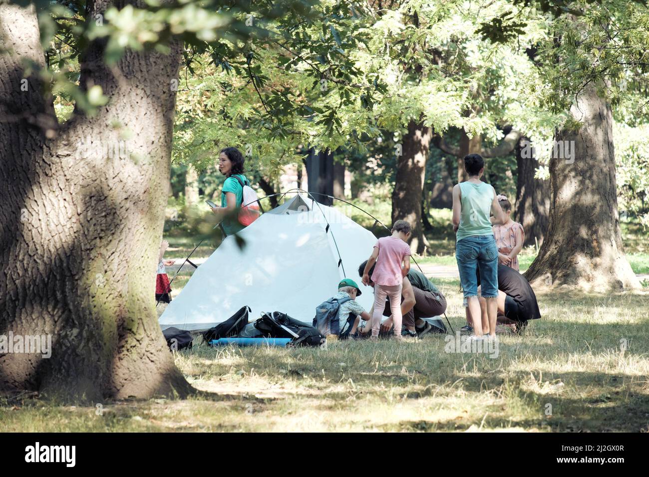 SOFIA, BULGARIA - AUGUST 04, 2017: women teaching to children how to pitch a tent in a Sofia Park Stock Photo