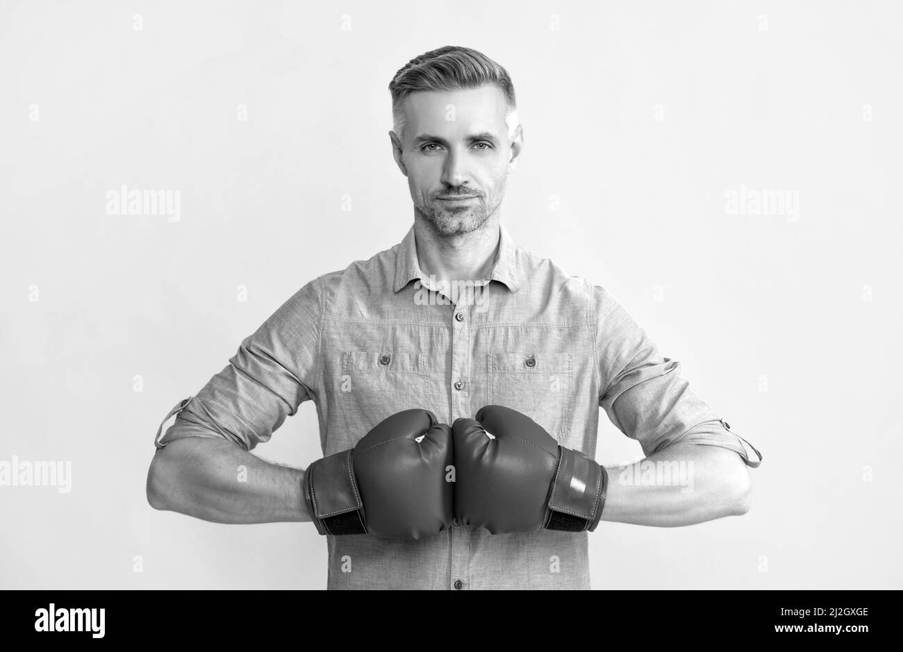 man in boxing gloves on yellow background, success Stock Photo