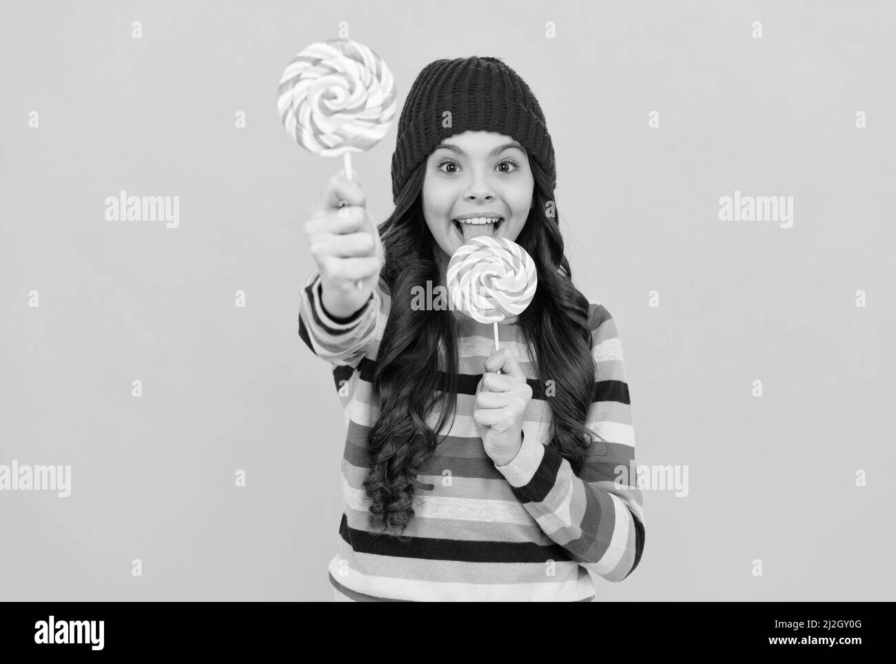 yummy. selective focus. happy teen girl licking lollipop. lollipop lady. kid with colorful lollypop Stock Photo
