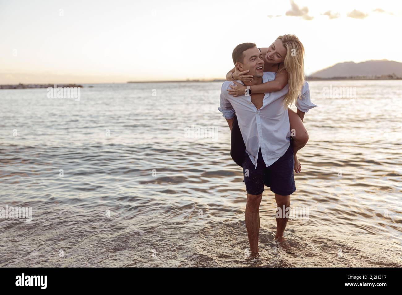 Full length photo of cute couple having fun together on beach ...