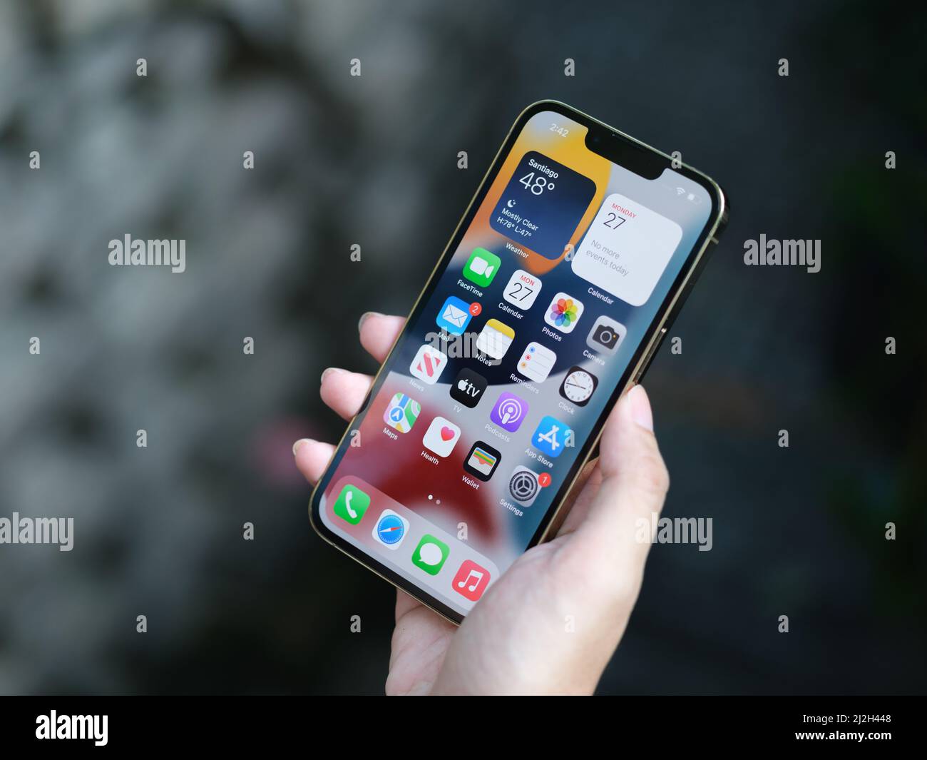 HCMC, Vietnam - August 19, 2021: View of new iPhone 13 or iPhone 13 Pro and Apple Airpods for editorial use Stock Photo